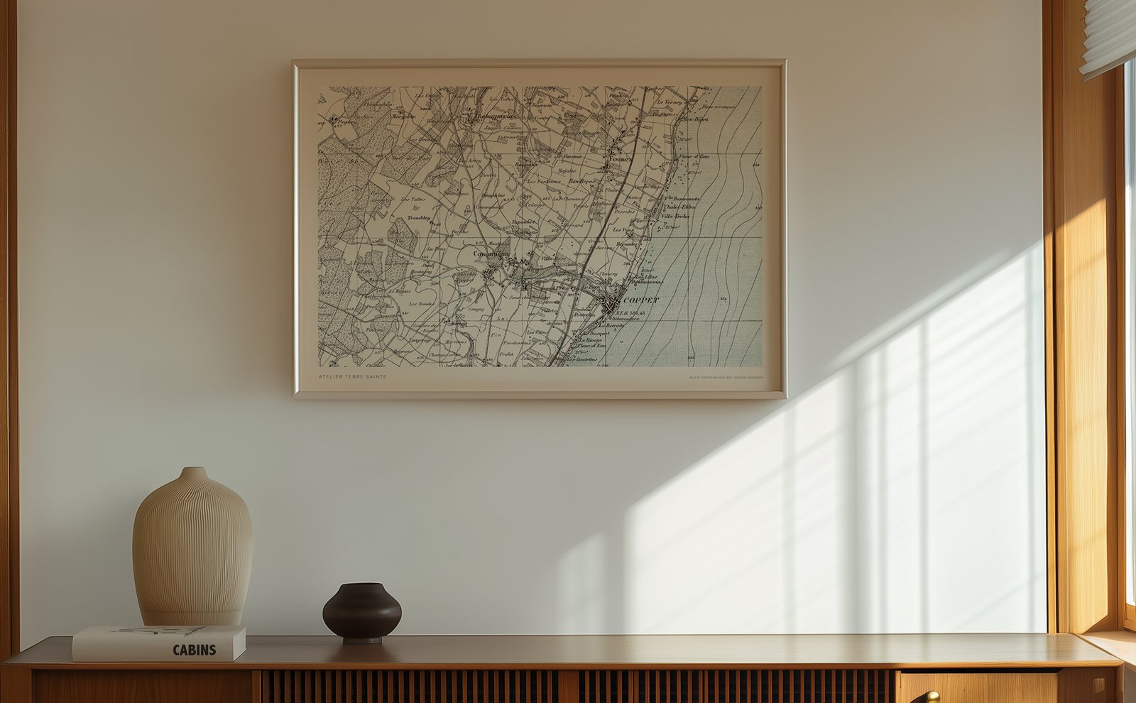 Luxury wall decoration featuring a large framed historical map of Terre Sainte Switzerland, natural oak frame on a minimalist textured wall, high-end interior design for a Swiss villa.